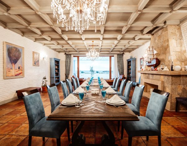 restaurant table 12 persons with blue chairs fireplace white brick walls wide window
